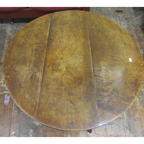 2655 - A Georgian oak snap top table the circular top 80 cm in diameter, raised on a turned pillar and shap... 