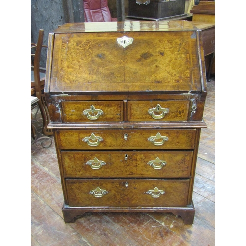 2667 - A small 18th century walnut and figured walnut writing bureau enclosed by three long and two short g... 