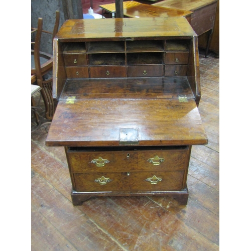 2667 - A small 18th century walnut and figured walnut writing bureau enclosed by three long and two short g... 