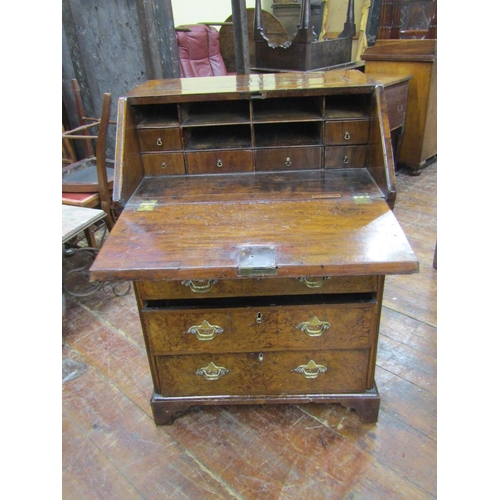 2667 - A small 18th century walnut and figured walnut writing bureau enclosed by three long and two short g... 