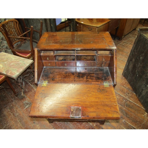 2667 - A small 18th century walnut and figured walnut writing bureau enclosed by three long and two short g... 