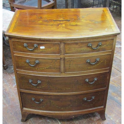 2672 - A small Edwardian mahogany chest of two long and four short drawers with bow fronted outline on swep... 