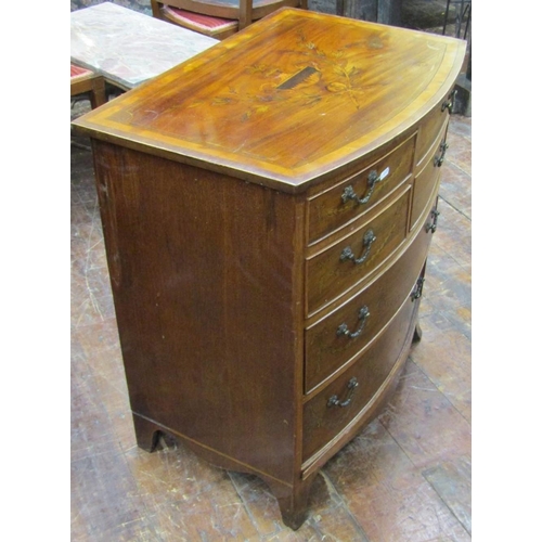 2672 - A small Edwardian mahogany chest of two long and four short drawers with bow fronted outline on swep... 