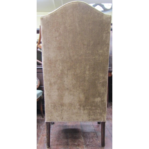 2676 - A substantial Georgian style wing chair with scrolled arms raised on a carved frame, cabriole forele... 