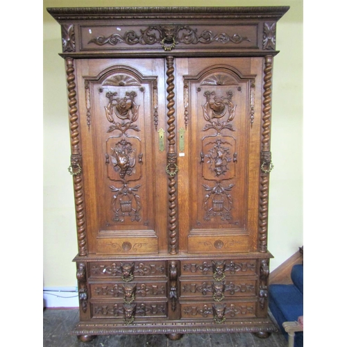 2677 - A substantial 19th century oak bookcase, the front elevation enclosed by a series of six short drawe... 