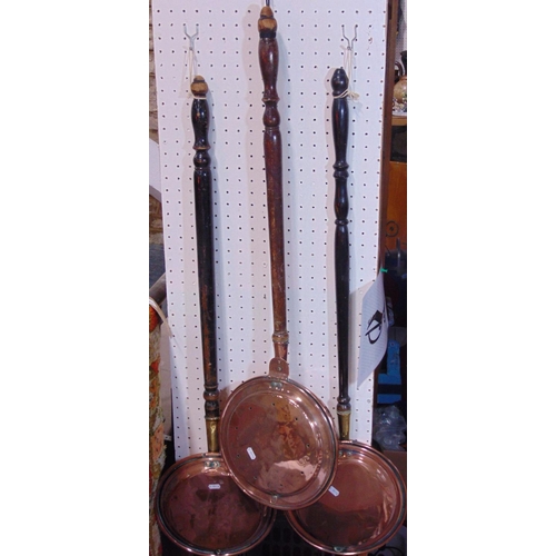 1871 - 3 19th century warming pans with turned wood handles.