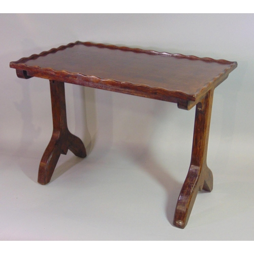 543 - An Arts & Crafts style oak occasional table of rectangular form with pie crust moulded edge, raised ... 