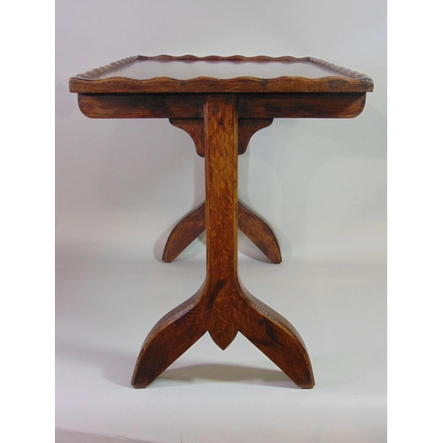 543 - An Arts & Crafts style oak occasional table of rectangular form with pie crust moulded edge, raised ... 