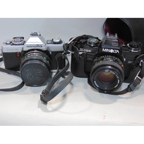 565 - Box of manual 35mm SLR cameras to include Minolta, Pentax and Canon, most with prime and zoom lenses