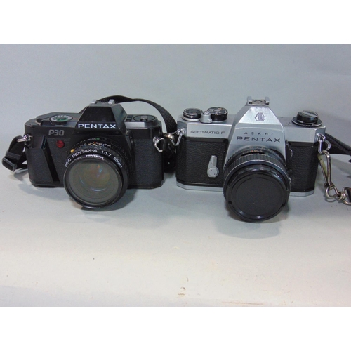 565 - Box of manual 35mm SLR cameras to include Minolta, Pentax and Canon, most with prime and zoom lenses