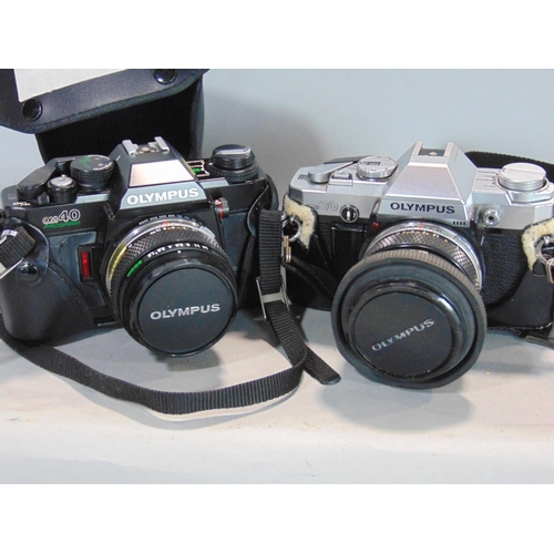 568 - An assortment of Olympus 35mm manual SLR cameras and other Olympus products to include an XA (boxed)