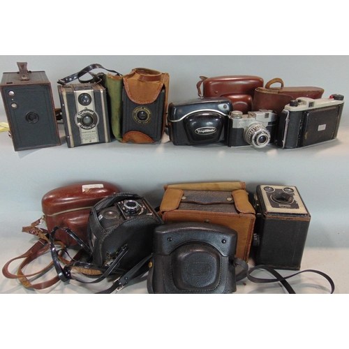 571 - A box of old cameras to include box cameras and folding.