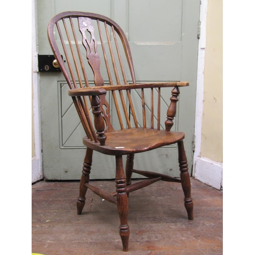 2649 - A Georgian ashwood Windsor elbow chair with shaped and pierced splat, dished seat on turned supports... 