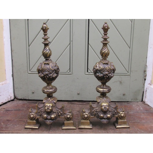 2666 - A pair of late 18th century cast brass andirons with repeating fruit, mask and floral detail raised ... 