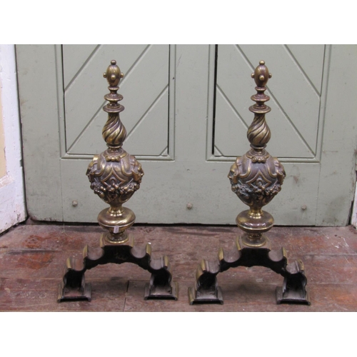 2666 - A pair of late 18th century cast brass andirons with repeating fruit, mask and floral detail raised ... 