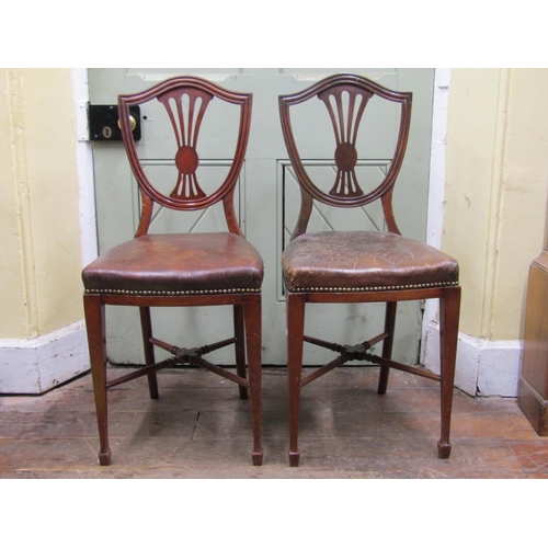 2668 - A pair of unusual 19th century mahogany side/hall chairs, the high seats (50 cm) upholstered in hide... 