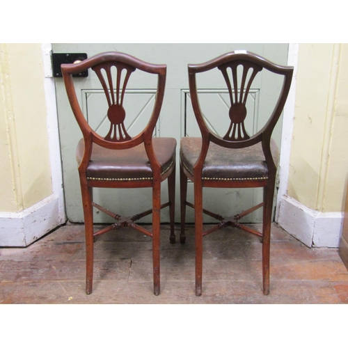 2668 - A pair of unusual 19th century mahogany side/hall chairs, the high seats (50 cm) upholstered in hide... 