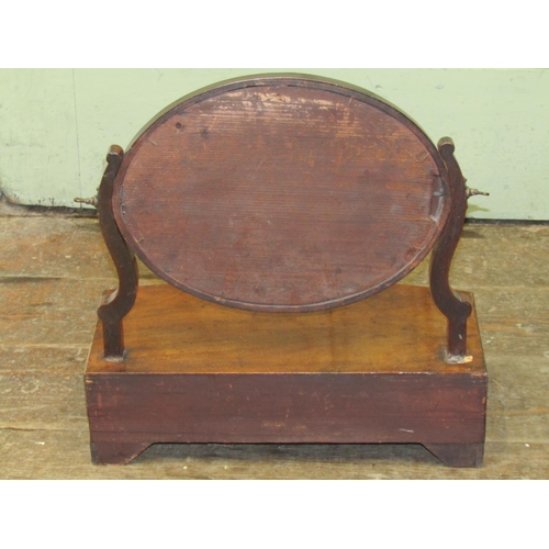 2679 - A simple Georgian mahogany toilet mirror, the oval mirror plate raised on a bow fronted base incorpo... 