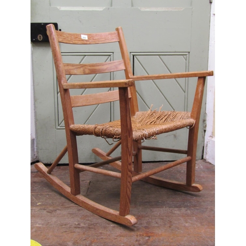 2682 - A simple country made pine framed rocking chair with ladderback and seagrass seat