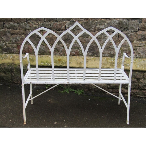 2043 - A painted ironwork gothic style two seat garden bench with pierced lancet interlaced back over a str... 