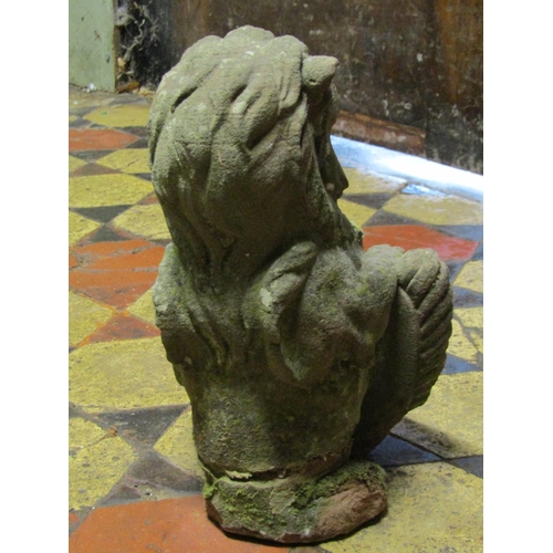 2082 - A small antique weathered carved sandstone lion finial clutching a shield, 32 cm  in height