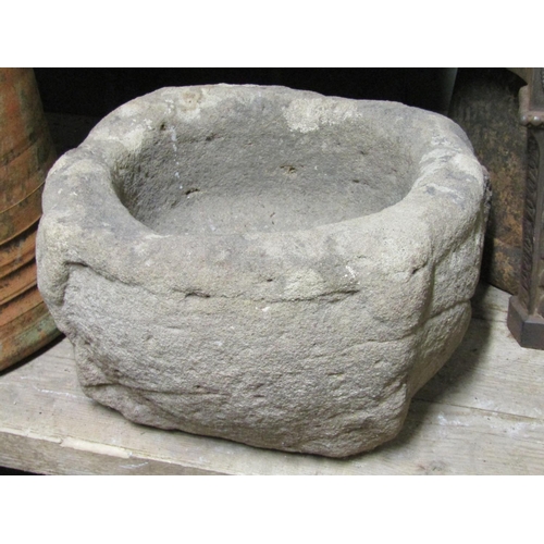 2082A - An early carved natural stone mortar or quern 30cm in diameter approximately