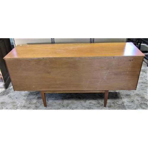 2295 - A mid 20th century teak sideboard fitted with a tower of three central drawers flanked by cupboards ... 