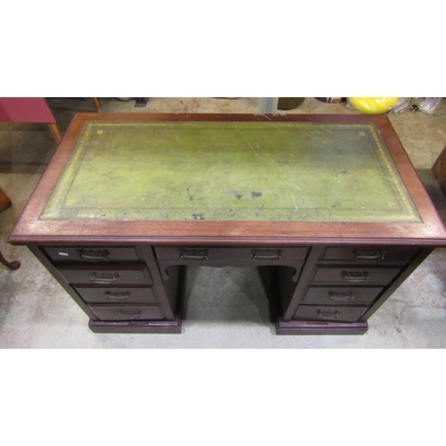 2301 - An Edwardian walnut kneehole twin pedestal writing desk with green inset panelled top over an arrang... 