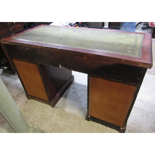 2301 - An Edwardian walnut kneehole twin pedestal writing desk with green inset panelled top over an arrang... 