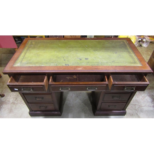 2301 - An Edwardian walnut kneehole twin pedestal writing desk with green inset panelled top over an arrang... 