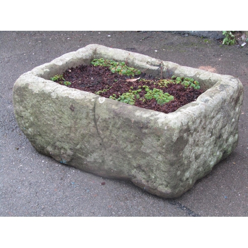 2031 - A weathered natural stone trough of rectangular form (cracked), 62 cm long x 41 cm wide x 26 cm in h... 