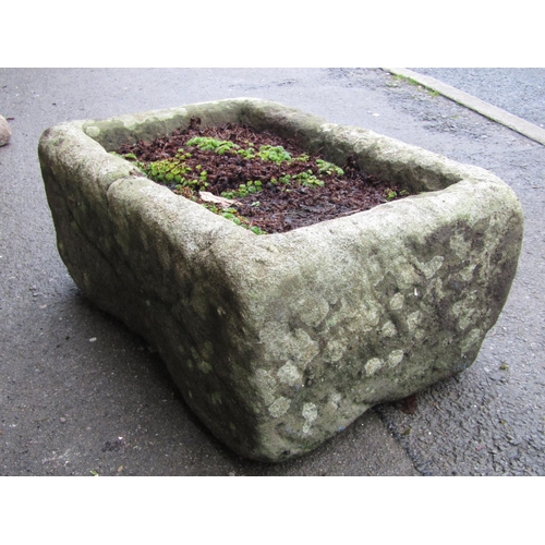 2031 - A weathered natural stone trough of rectangular form (cracked), 62 cm long x 41 cm wide x 26 cm in h... 