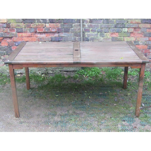 2042 - A weathered contemporary teak garden table of rectangular form with slatted panelled top and square ... 