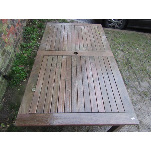 2042 - A weathered contemporary teak garden table of rectangular form with slatted panelled top and square ... 