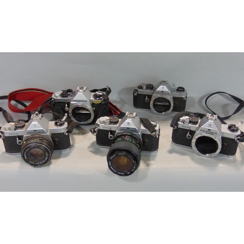 587 - A flight type padded case containing five vintage Pentax cameras with various lenses and flash units... 