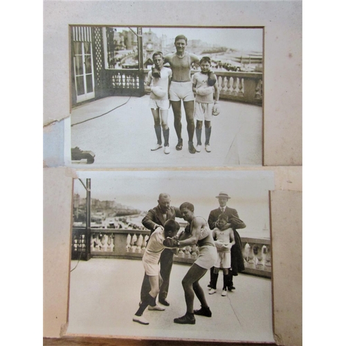 422 - A quantity of early 20th century black and white photographs of young boxers together with a poster ... 