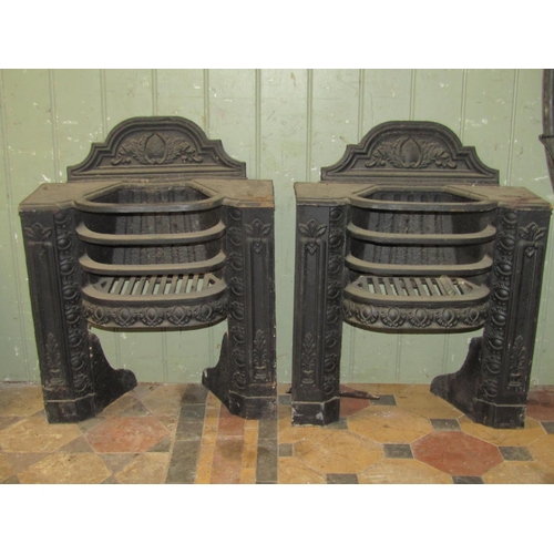 2102 - A pair of small 19th century cast iron bedroom grates, with bow fronted basket and  raised foliate r... 