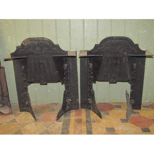 2102 - A pair of small 19th century cast iron bedroom grates, with bow fronted basket and  raised foliate r... 