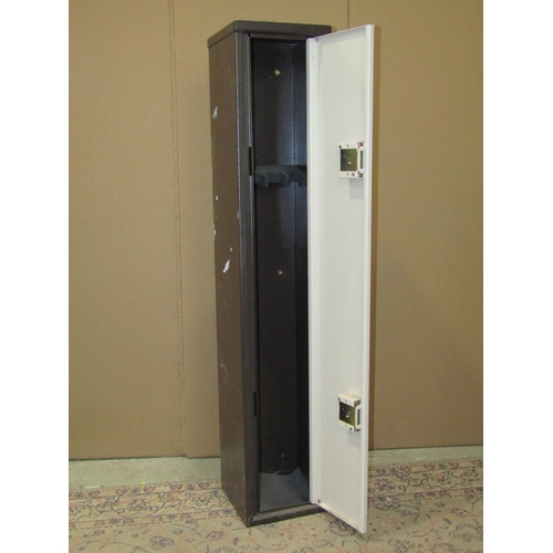 2125 - A steel gun cabinet enclosed by a single full length door with two locks and keys (brown and cream c... 