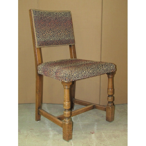 2132 - A set of four reproduction Old English style oak framed dining chairs with upholstered seats and pad... 