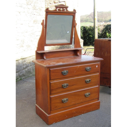 2182 - An Edwardian satin walnut dressing chest of three long graduated drawers beneath a central swing mir... 