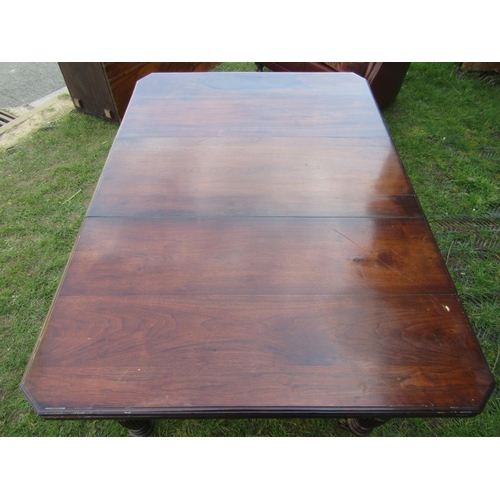 2183 - An Edwardian walnut wind-out extending dining table of rectangular form with moulded outline, canted... 