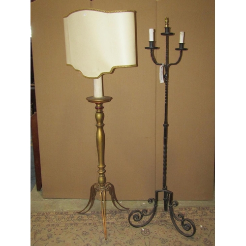 2190 - A ironwork three branch standard lamp with scrolled tripod supports together with a giltwood standar... 