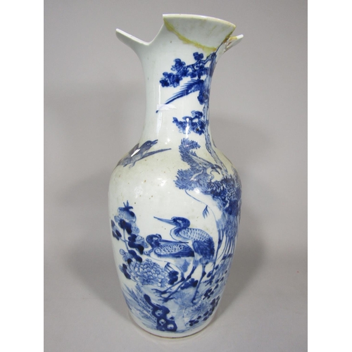 1067 - A 19th century oriental blue and white baluster shaped vase with painted bird and flowering tree dec... 