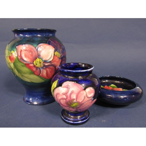 1076 - A collection of Moorcroft blue ground wares comprising a vase with anemone decoration painted signat... 