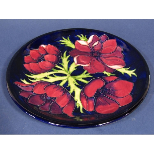 1077 - A Moorcroft pottery blue ground plate with anemone decoration and impressed marks to reverse, 26 cm ... 