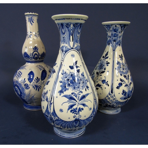 1093 - A pair of Dutch delft blue and white vases with floral decoration 31 cm tall approximately together ... 