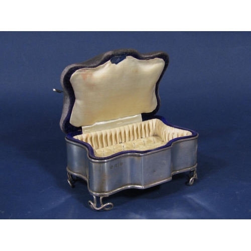 1280 - Early 20th century silver ring box/pin cushion, the hinged top over serpentine body and fancy feet, ... 