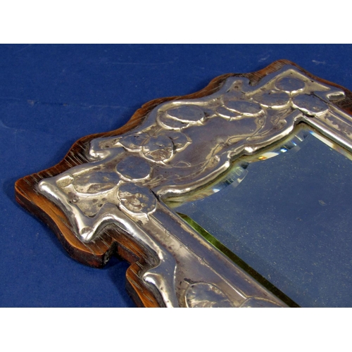 1303 - A good quality Arts & Crafts silver easel mirror, the shaped bevelled glass framed by embossed Art N... 