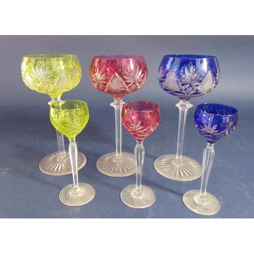 1191 - A collection of 12 (6 small, 6 large) coloured glass goblets comprising four blue, four yellow and f... 